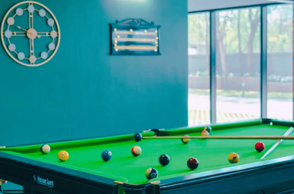Indoor games and recreation area at Ivy League House Pune with pool table and seating